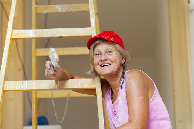 Woman doing a home remodeling job.